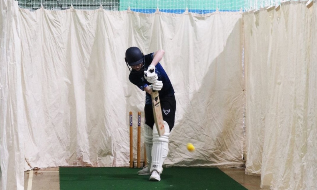 A child playing indoor cricket inside one of the newly installed net bays in Kennet Sports Hall, part of the school’s £46,000 cricket programme upgrad